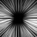 A black square in the middle of the image with black and white streaks surrounding it like and illusion.