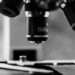 A black and white image of microscope objective lenses up close