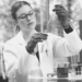 A person holding a pipette and test tube