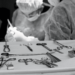 A person in a mask and gloves working on a device