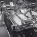 A group of robotic arms on a conveyor belt