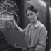 A person holding a computer